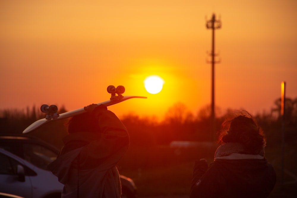 silhouette of man playing trumpet during sunset