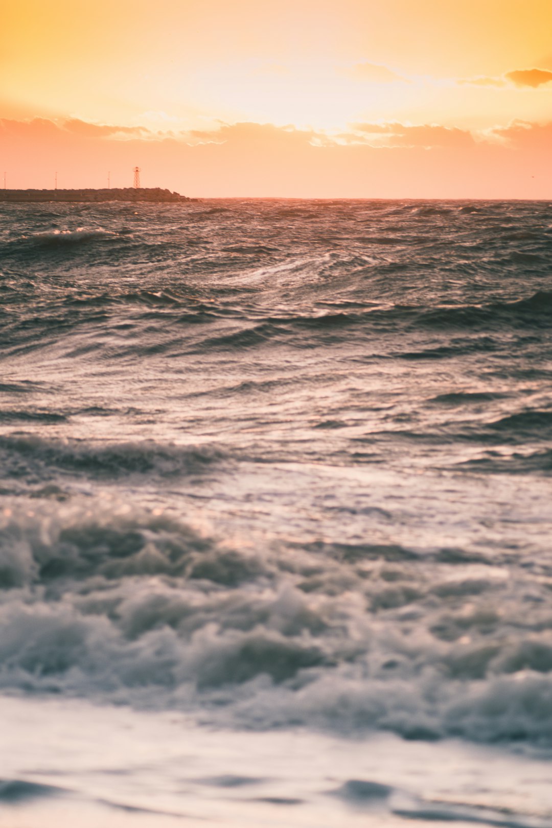 ocean waves crashing on shore during daytime