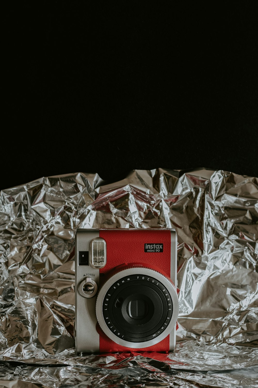 silver and black camera on silver foil