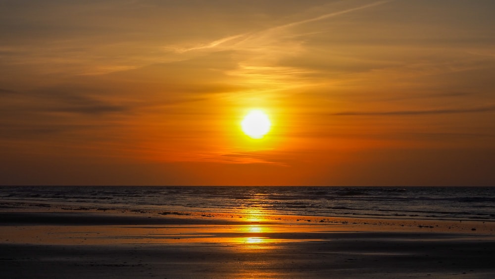 body of water during sunset