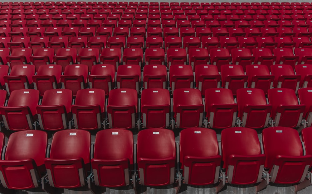 red plastic chair lot during daytime