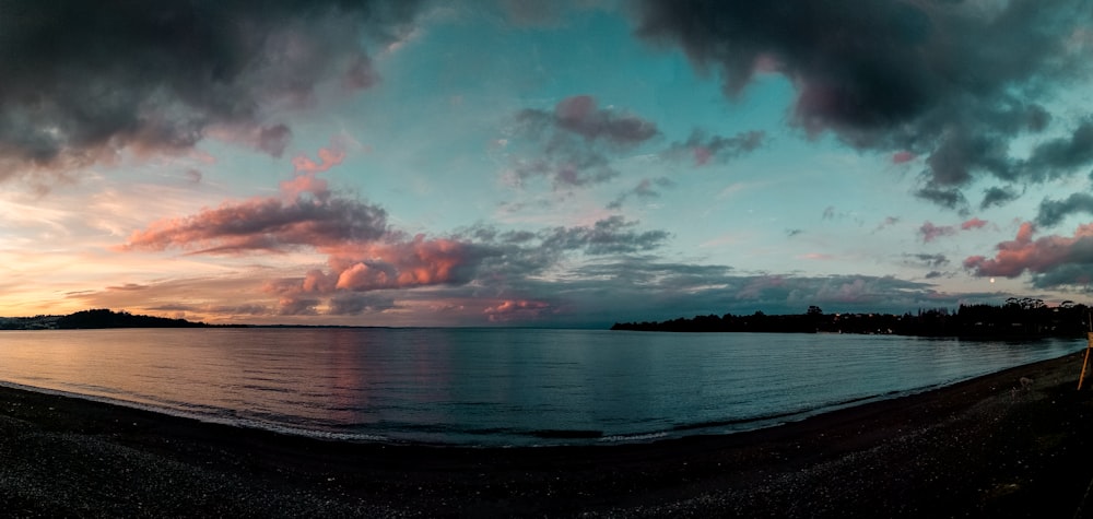 body of water under cloudy sky during daytime