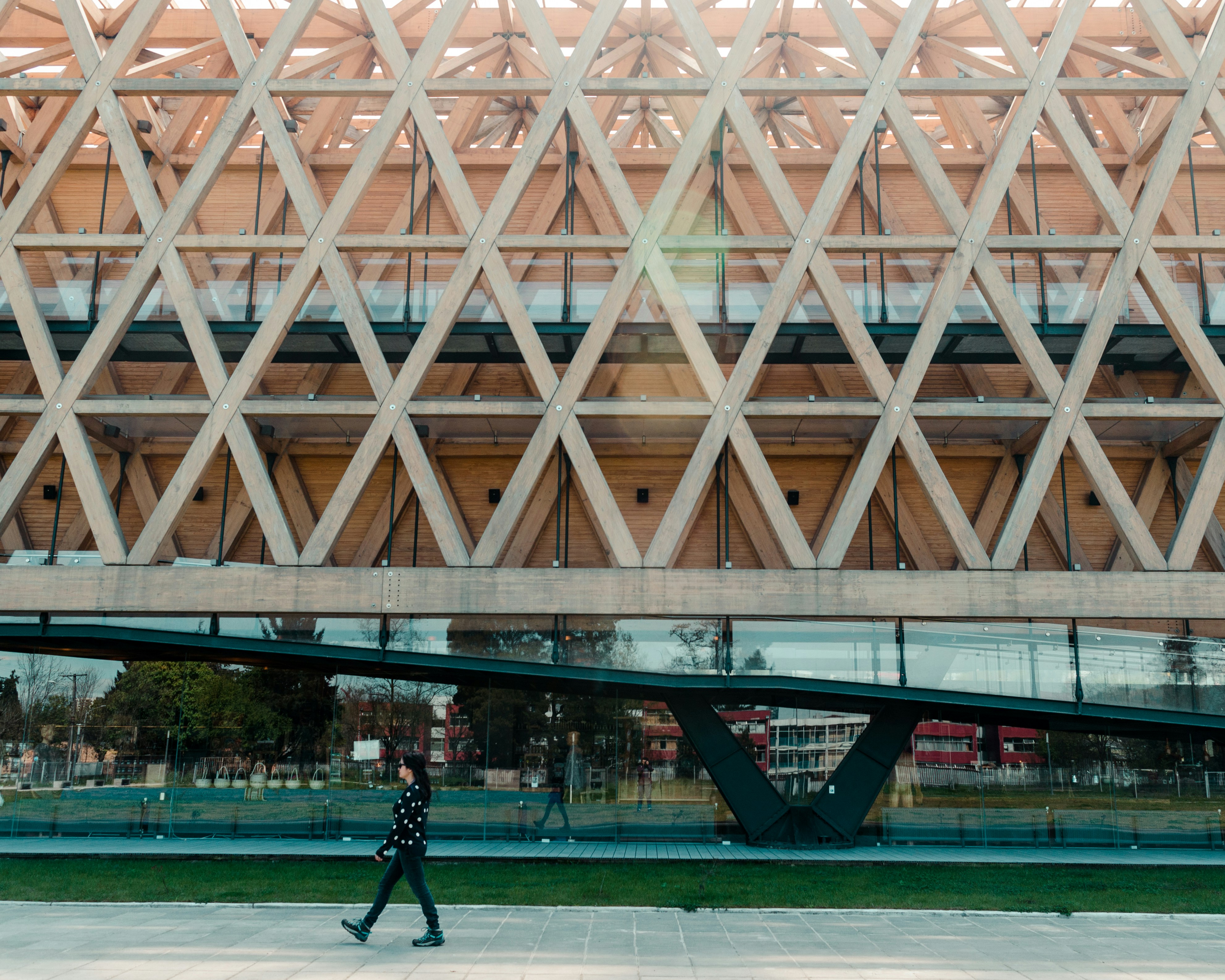 people walking on gray concrete pavement near brown building during daytime