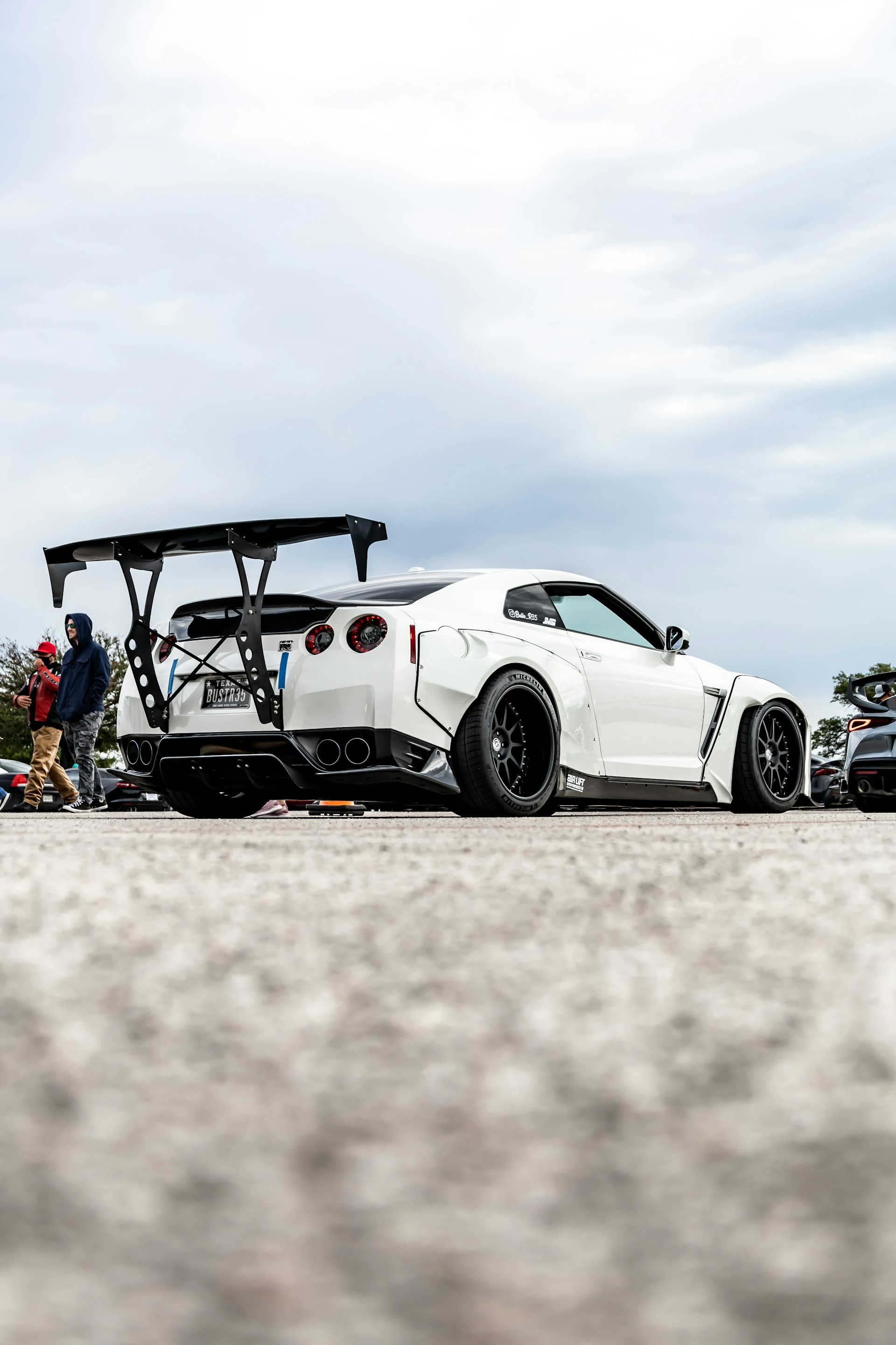 white and black coupe on white sand during daytime