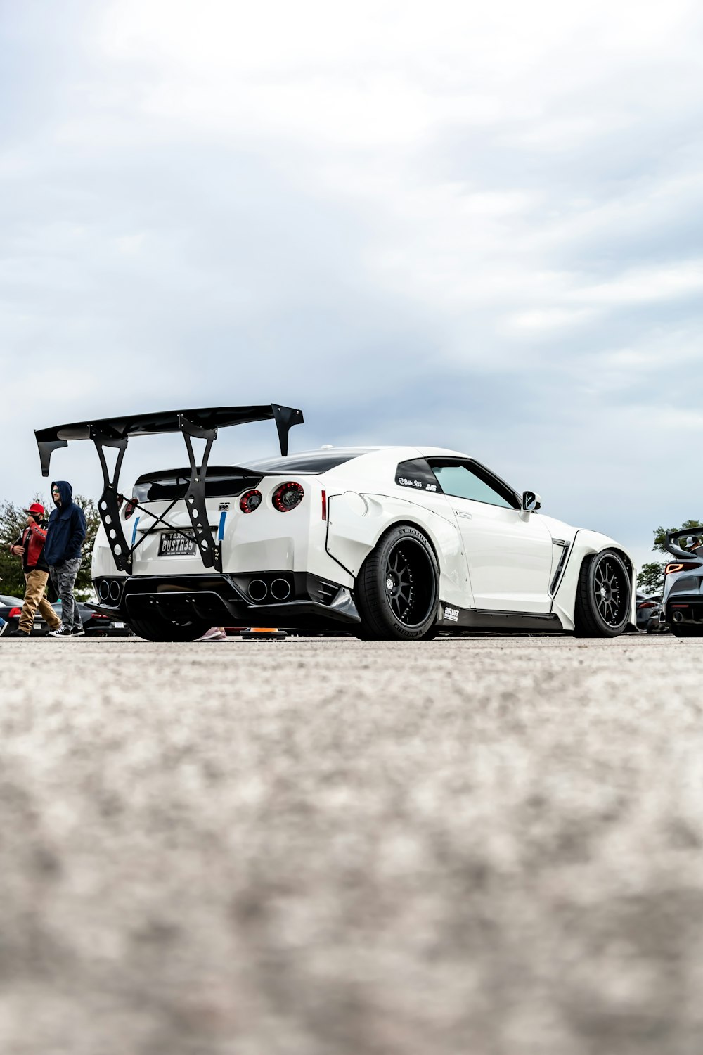 white and black coupe on white sand during daytime