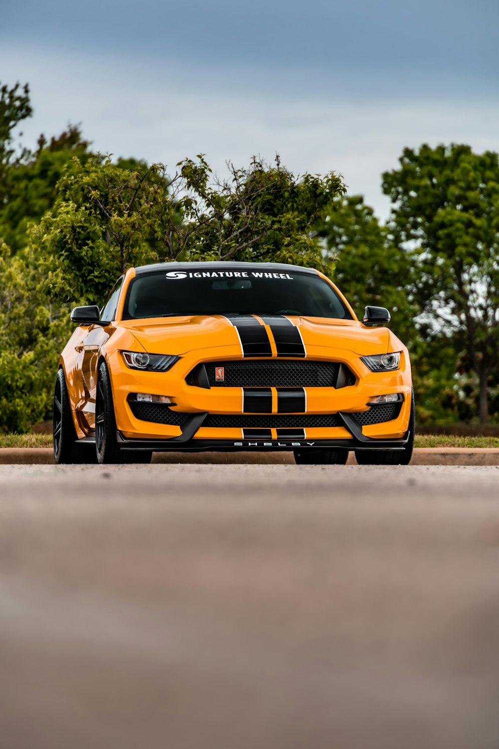 yellow chevrolet camaro on road during daytime