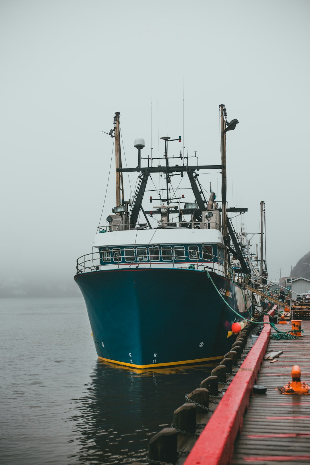 green and white ship on sea during daytime