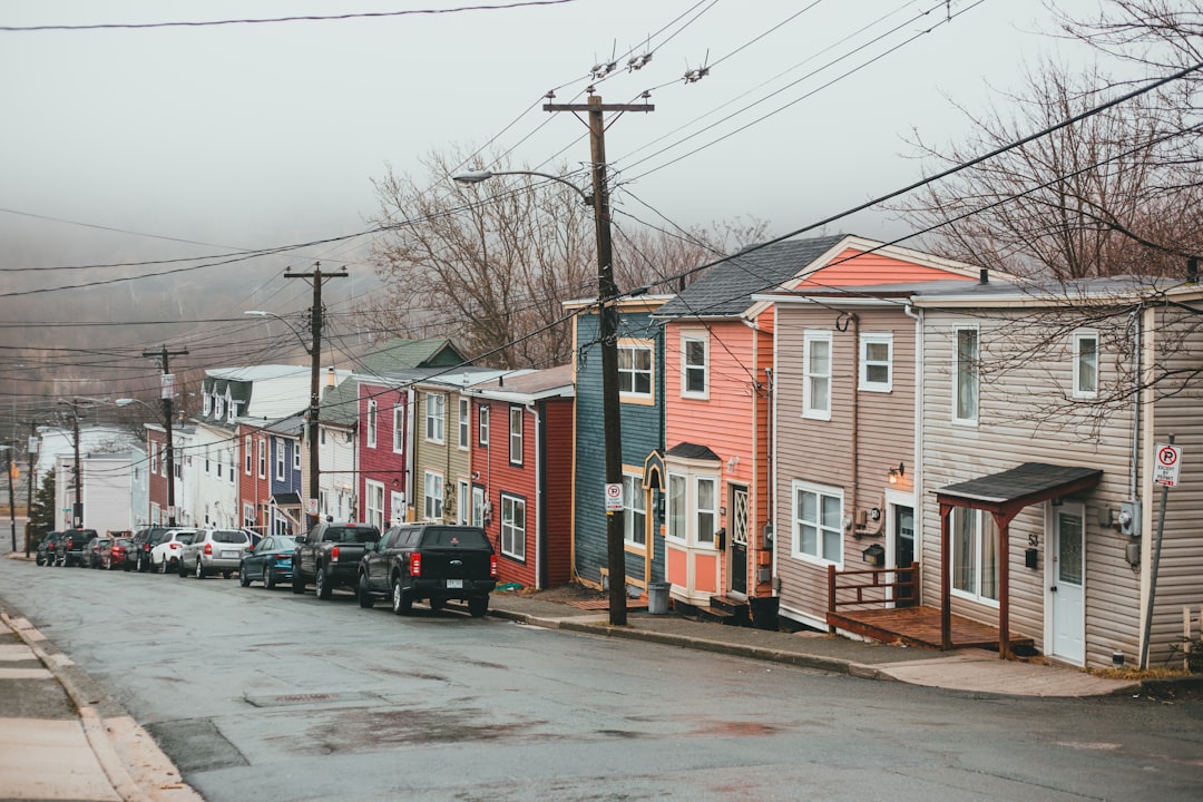 cars parked in front of houses during daytime