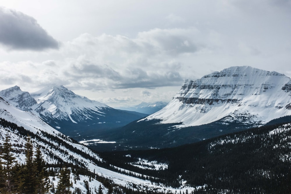 snow covered mountain under cloudy sky during daytime