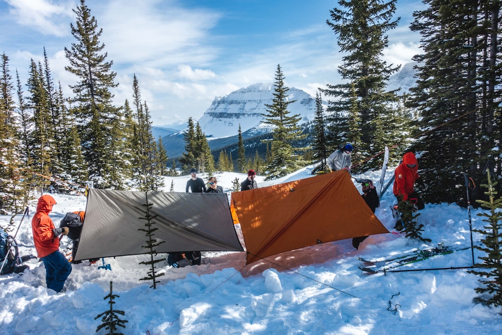 group of people in tent on snow covered ground during daytime