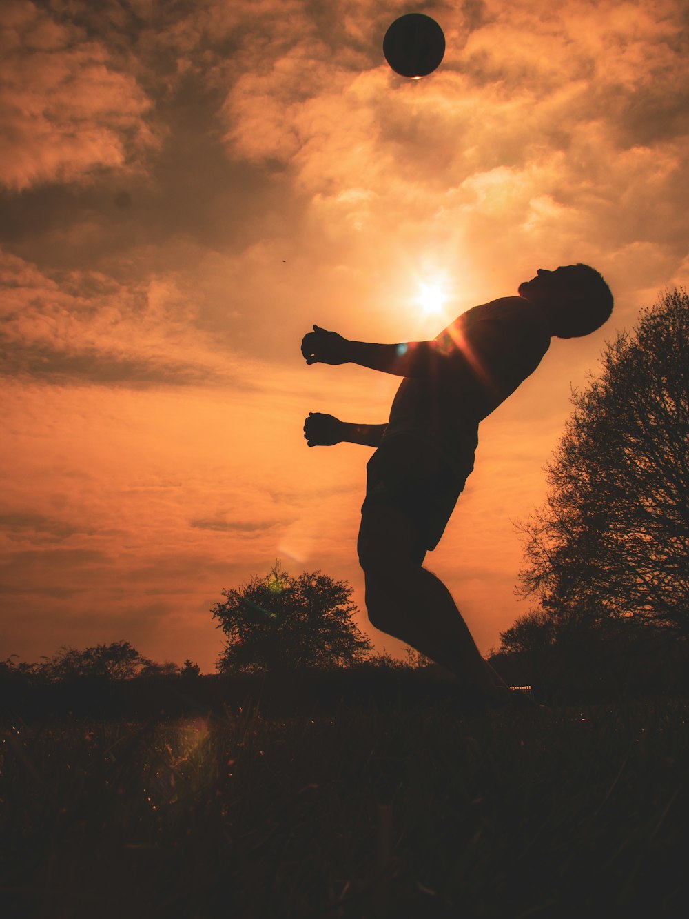 silhouette of man jumping during sunset
