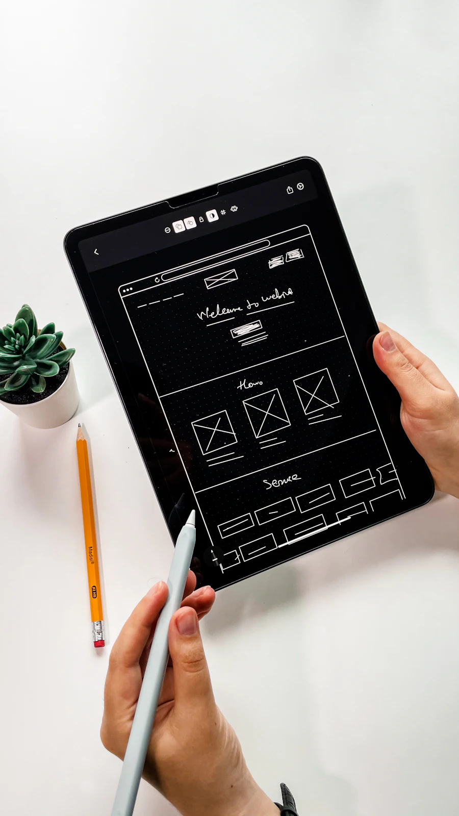 A tablet showing an app interface wireframe