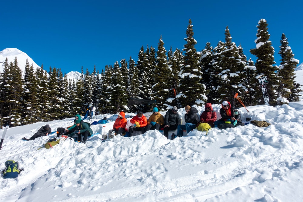 people riding on sled on snow covered ground during daytime