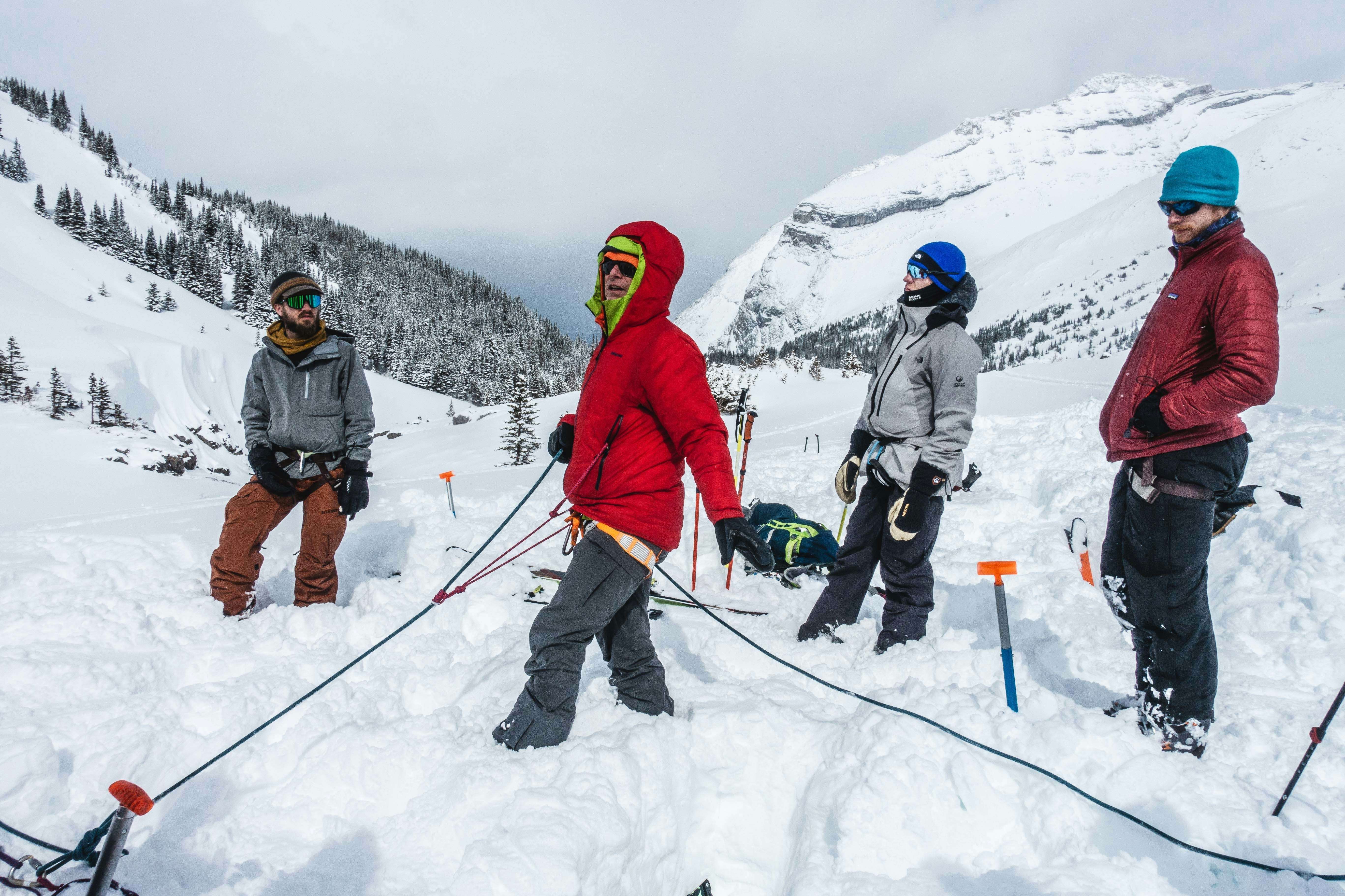 3 person in winter jacket standing on snow covered ground during daytime