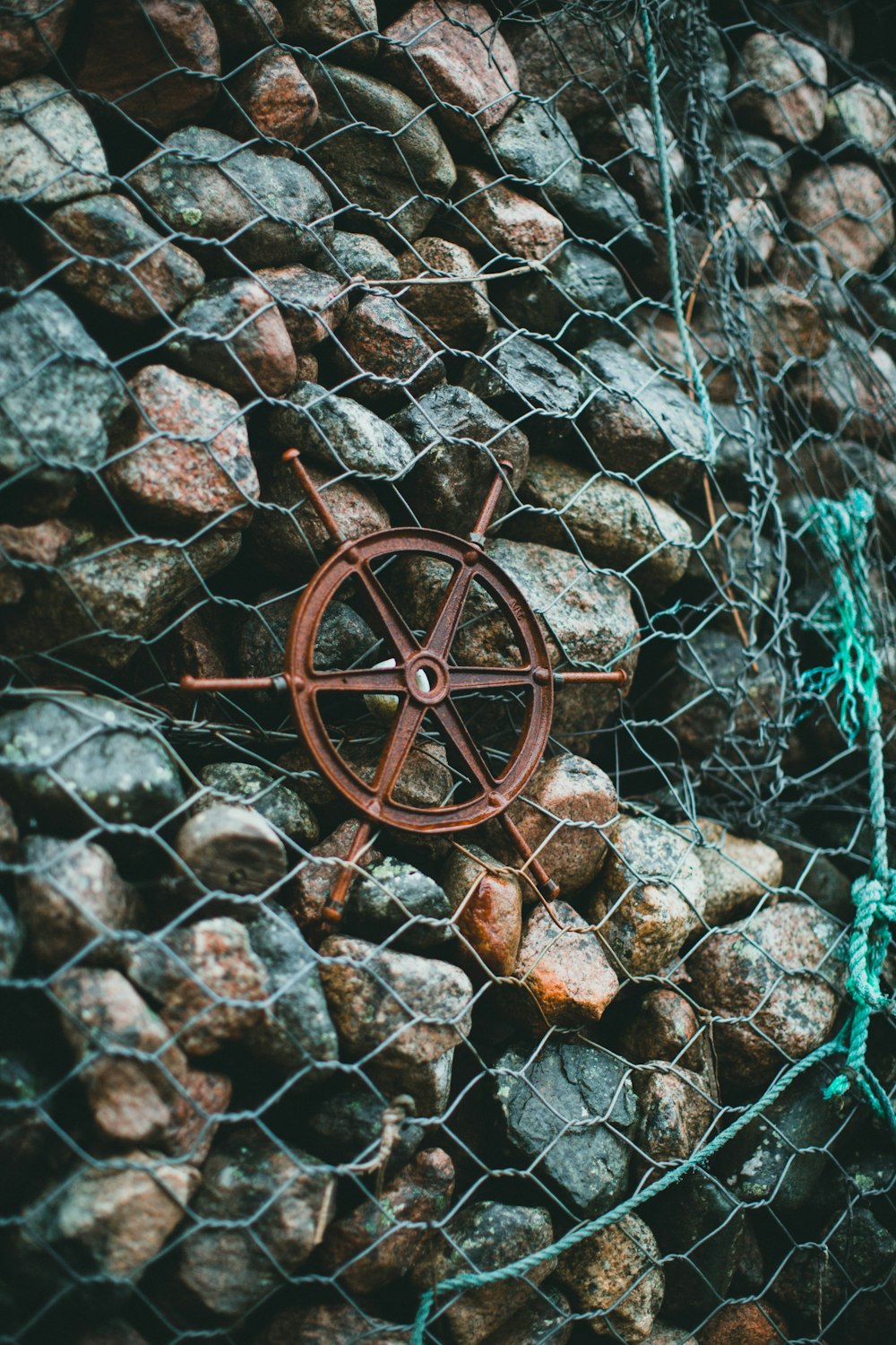 brown metal wheel on brown and gray rock