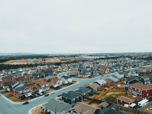 A blueprint sketch overlaying a neighborhood street with duplex houses.