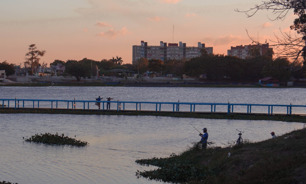 people walking on gray concrete bridge during daytime