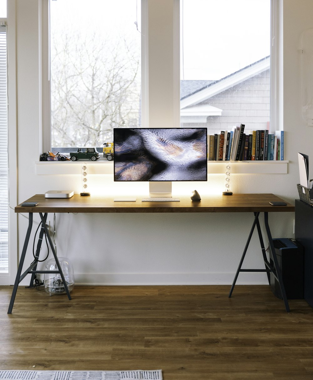 silver imac on brown wooden table