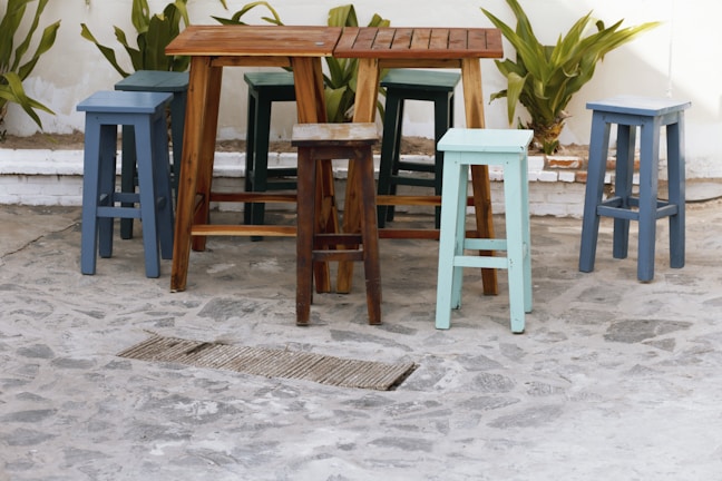 Elegant patio bar stools arranged around a table.