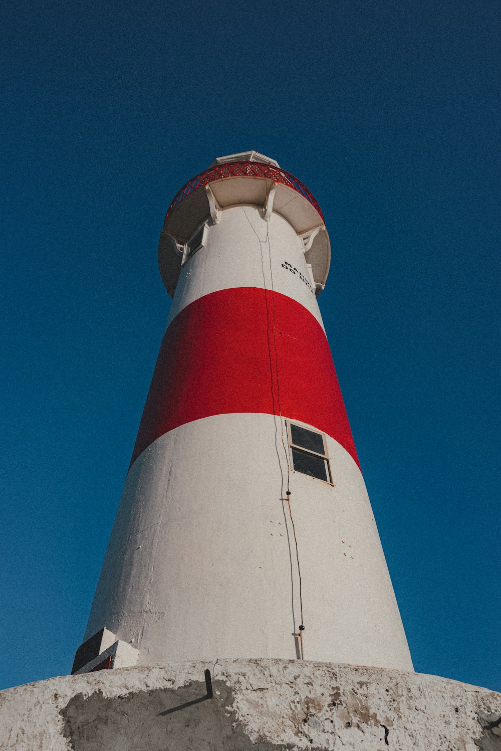 white and red lighthouse under blue sky during daytime