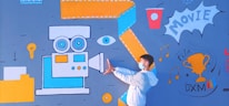 A person wearing a mask and white jacket poses in front of a vibrant mural. The mural includes a large vintage movie camera in blue and orange, an eye, a lightbulb, a cup, and a trophy labeled 'Film DXM'. Musical notes and the word 'MOVIE' are also part of the design.