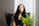 woman in blue sleeveless dress sitting on black couch