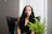 woman in blue sleeveless dress sitting on black couch