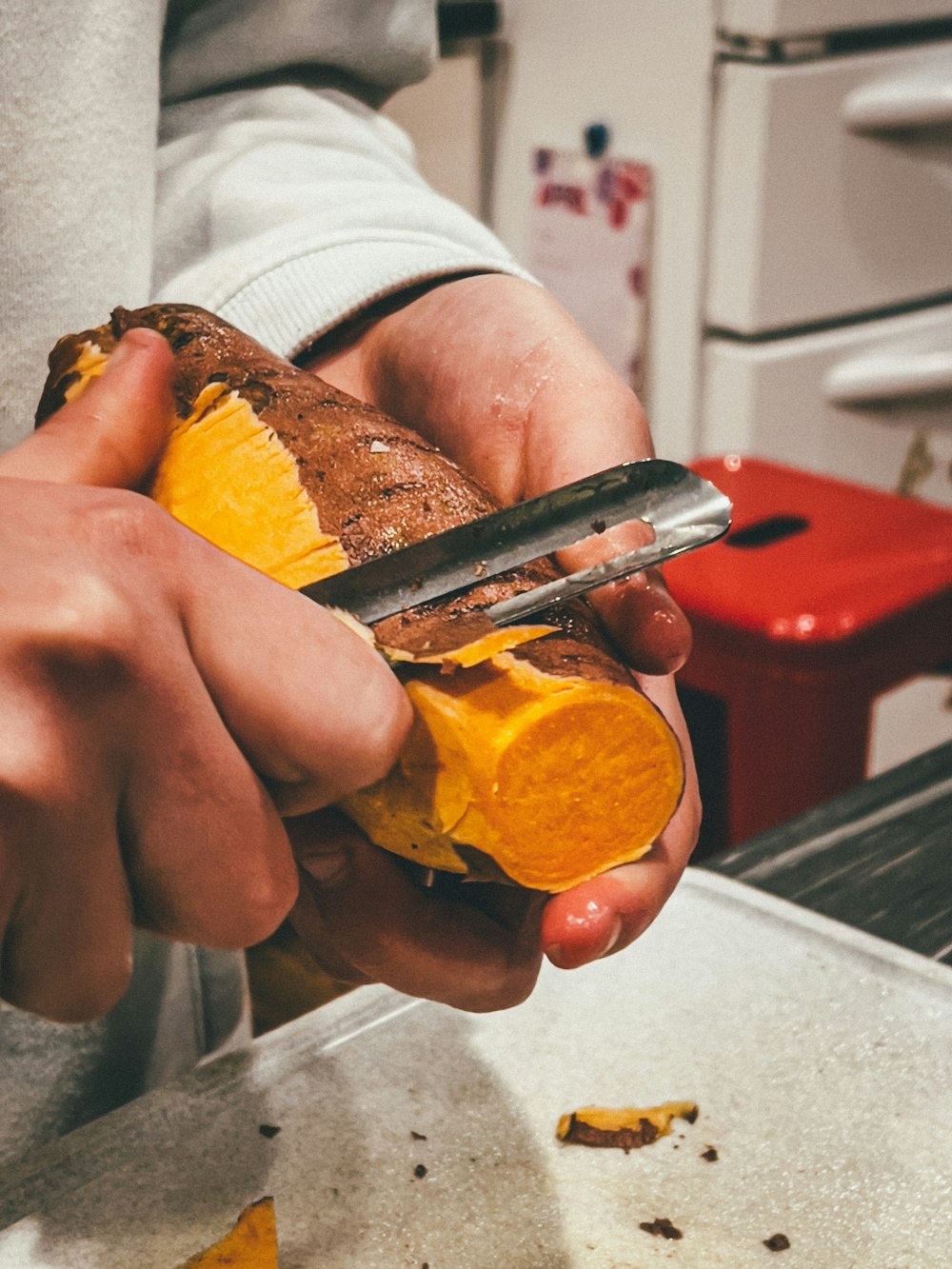 person holding sliced orange fruit