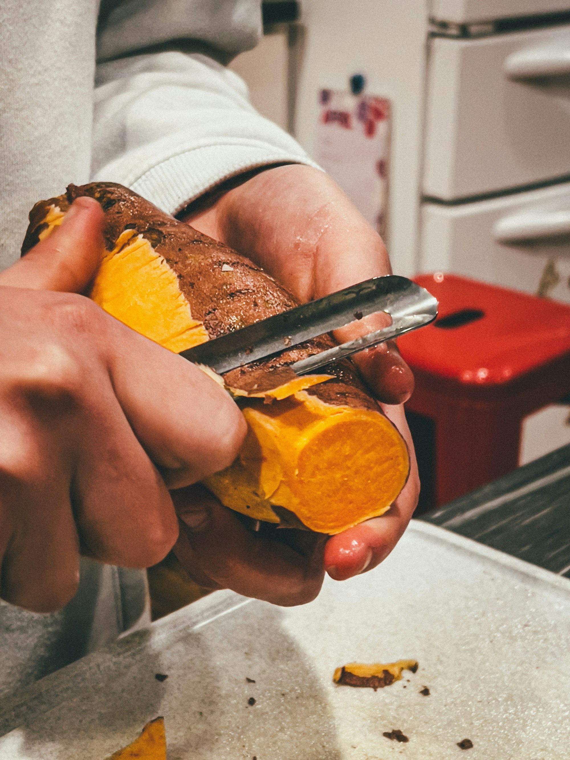 A person peels and prepares food