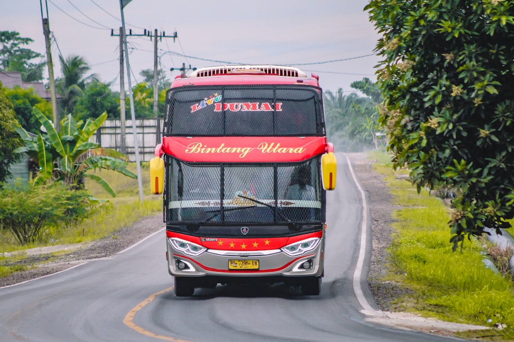 red and black bus on road during daytime