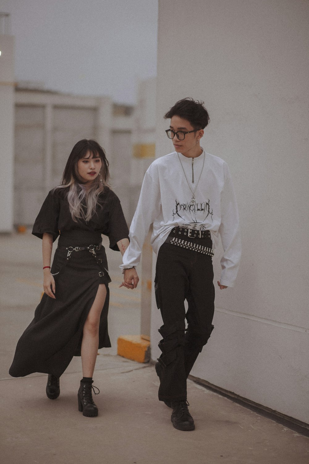 man in white long sleeve shirt and woman in black dress