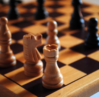 brown wooden chess piece on chess board