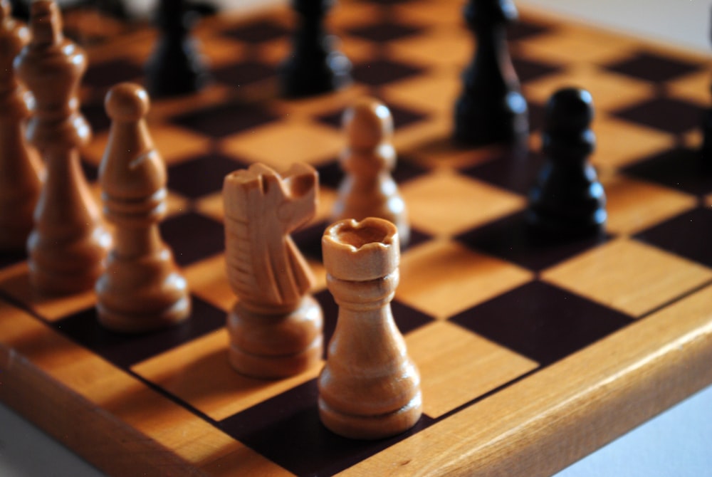 brown wooden chess piece on chess board