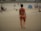 A customer enjoying the beach in a vibrant Way Rain swimsuit.