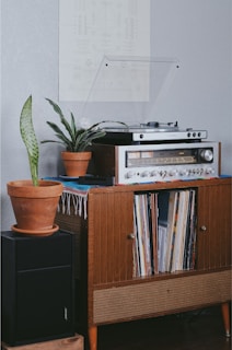 gray radio on brown wooden cabinet