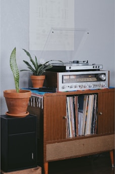 gray radio on brown wooden cabinet