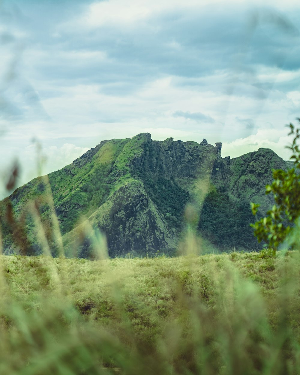 green mountain under white clouds during daytime