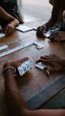 person holding white and black remote control