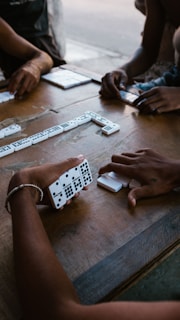 person holding white and black remote control