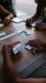 person holding white and black remote control
