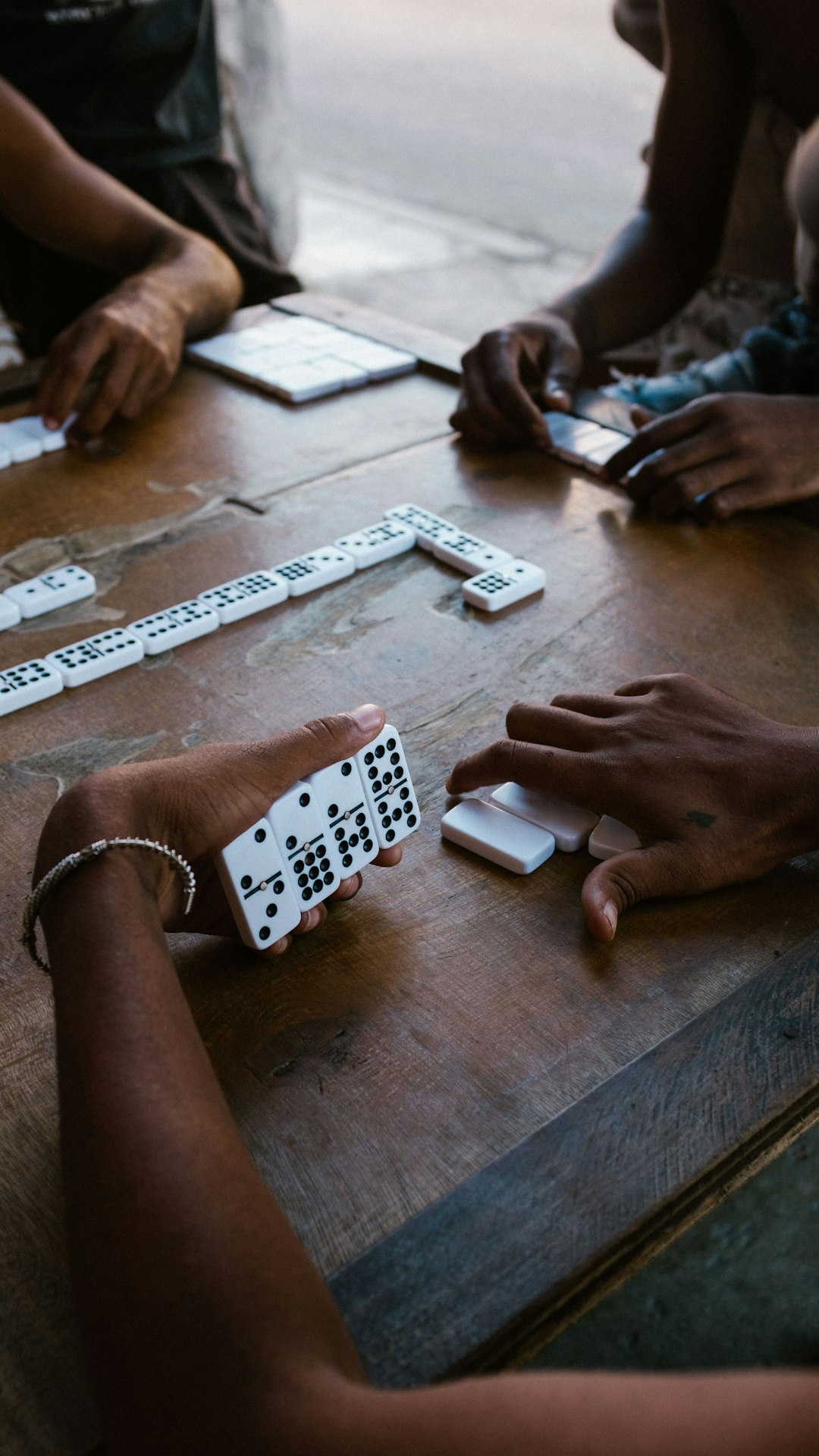 person holding white and black remote control