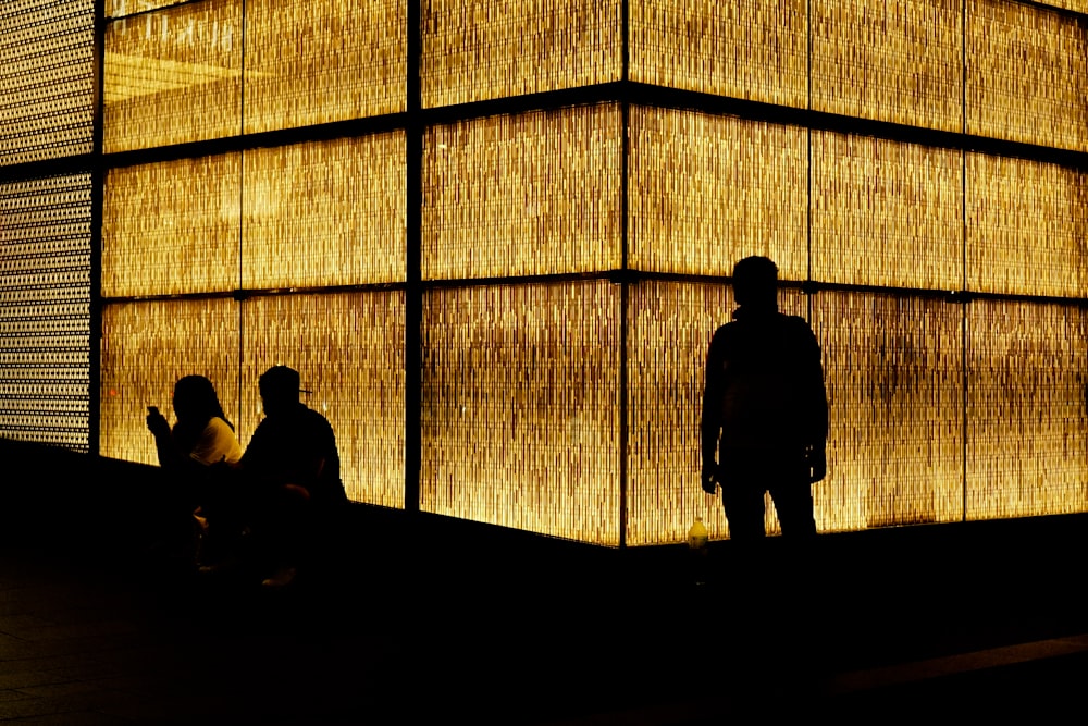 silhouette of 2 person sitting on chair