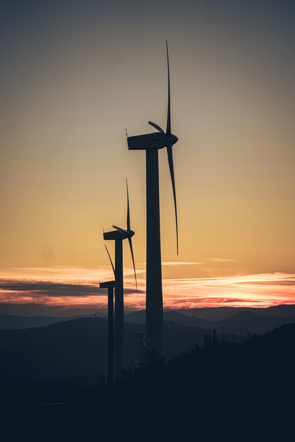 silhouette of wind mill during sunset