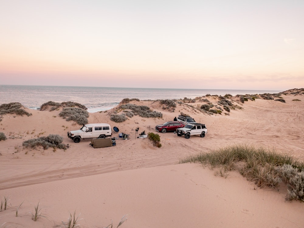 white suv on brown sand during daytime