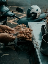 Close-up of delicious street food being prepared fresh on a portable grill.