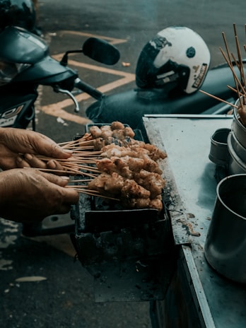 Close-up of delicious street food being prepared fresh on a portable grill.