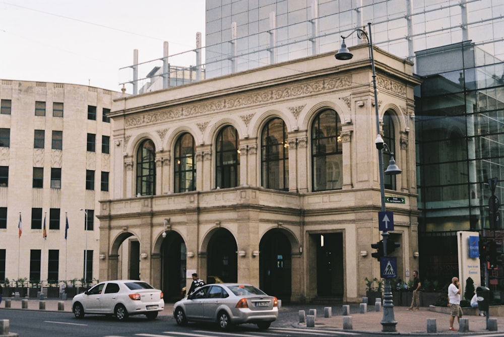 cars parked in front of beige concrete building during daytime