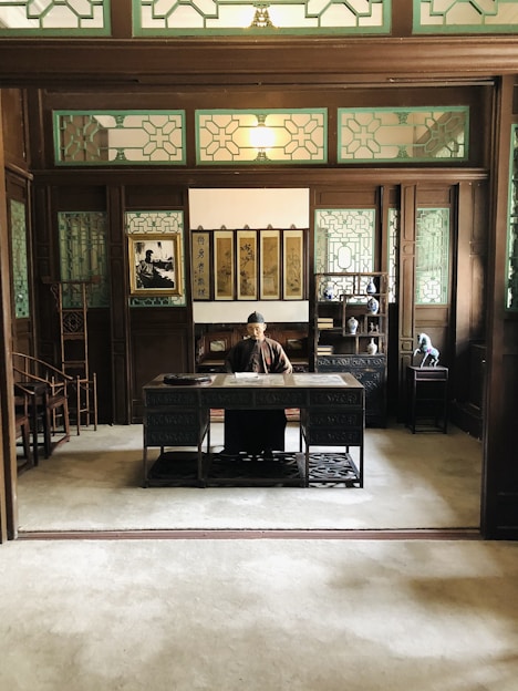 A young student enthusiastically using a laptop to practice quiz questions for China university entrance exams in a cozy study room.