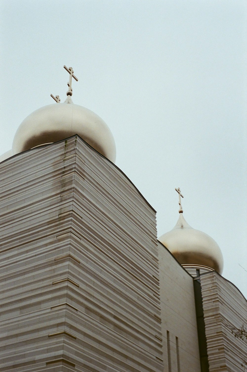 white concrete building under white sky during daytime