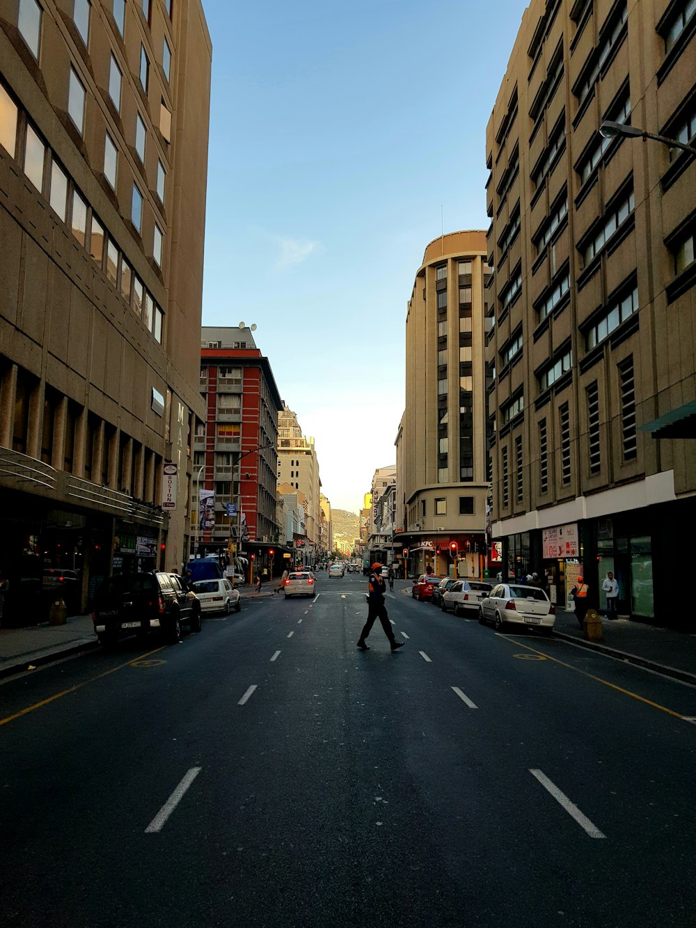 people walking on pedestrian lane near brown concrete building during daytime